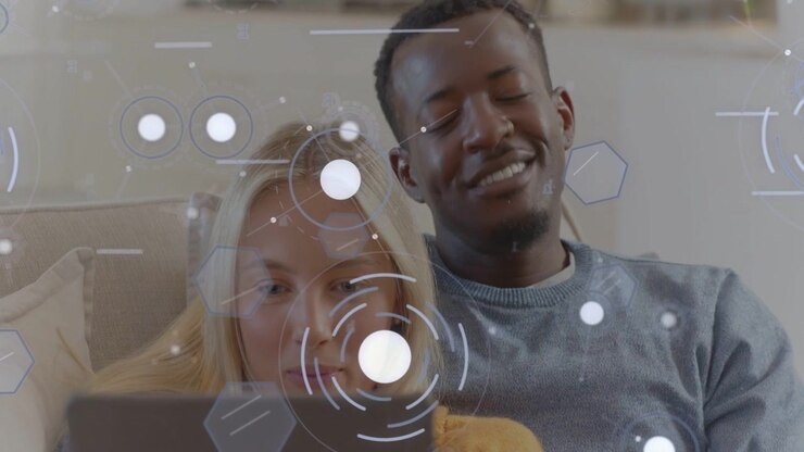 Reacting couple on sofa leaning toward tablet content at home, grey, mustard sweaters, HUD overlay