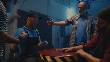 men engaging in a lively arm wrestling match and celebrating in a garage