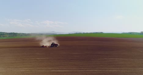 tractor working in beautiful spacious agricultural field 18