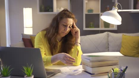 upset woman feeling worried about financial debt checking bills at home.