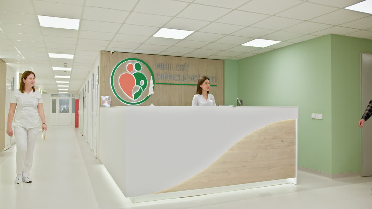 Couple Meeting with Healthcare Professional at Hospital Reception