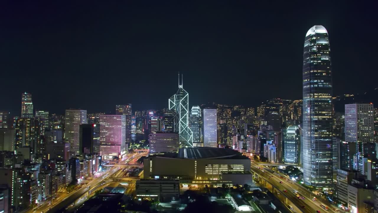 Stunning perspective of Hong Kong's skyline illuminated at night, showcasing modern skyscrapers and vibrant city life. The scene captures the dynamic atmosphere and architectural marvels of the city.