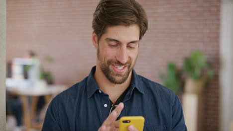 portrait-of-handsome-young-man-entrepreneur-using-smartphone-texting-networking-online-enjoying-mobile-phone-communication-reading-messages-slow-motion