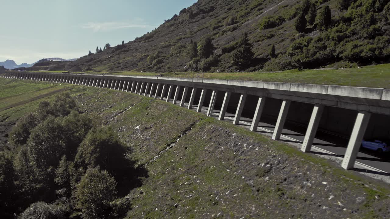 Aerial car driving in rock shed, beautiful calming mountain alpsine summer sunny landscape, K&uuml;htai, Austria