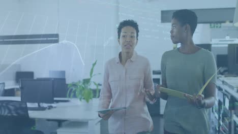 animation of stock market data processing over two diverse women discussing while walking at office