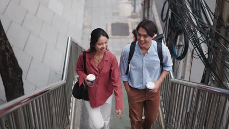 couple walking up stairs in city