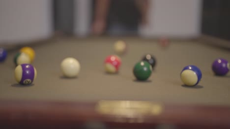 breaking colorful pool balls on green billiards table for start to play