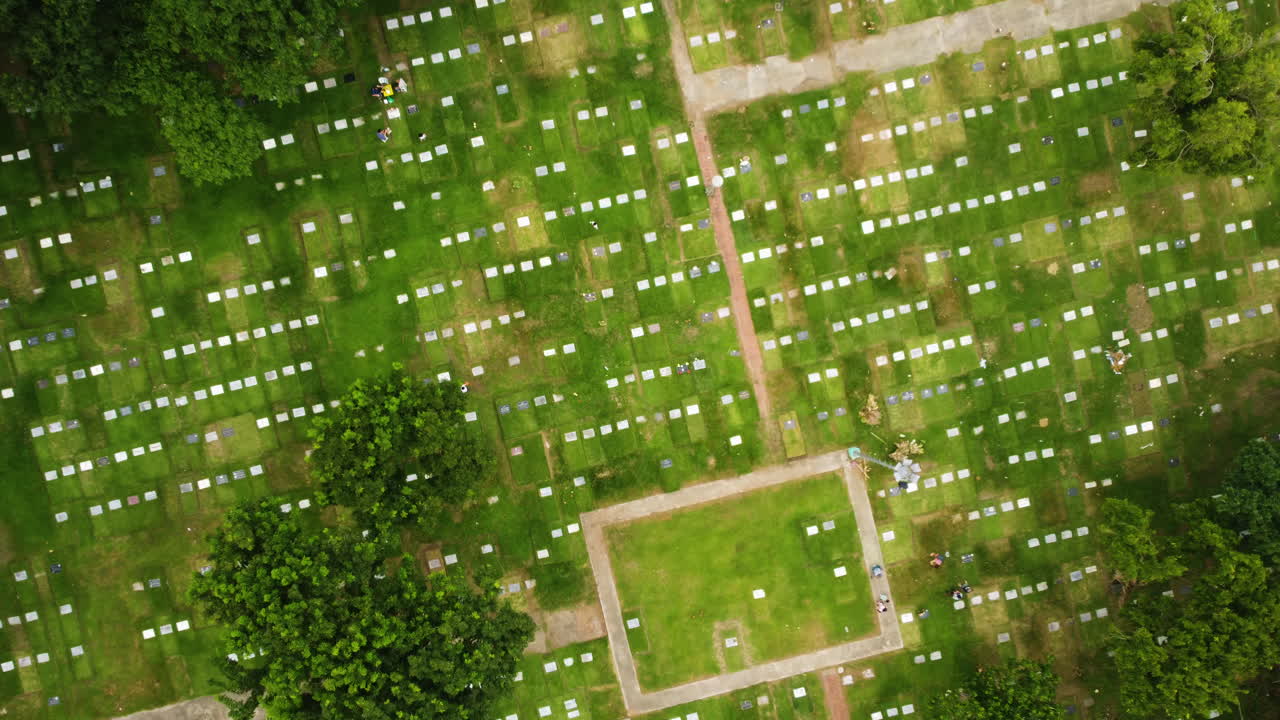 Overhead drone shot rotating above graves at Manila memorial park, Philippines
