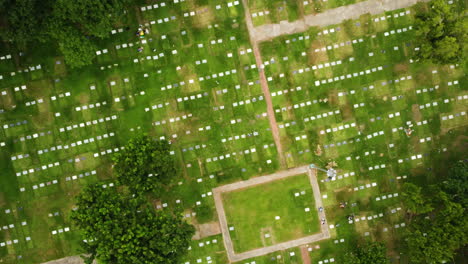overhead drone shot rotating above graves at manila memorial park, philippines