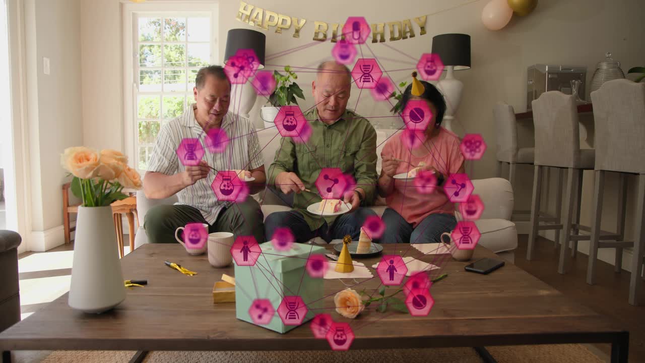 Trio sitting center man gesturing cutting cake marking birthday with AR showing nodes near faces