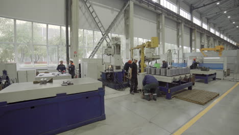 factory workers operating industrial machinery