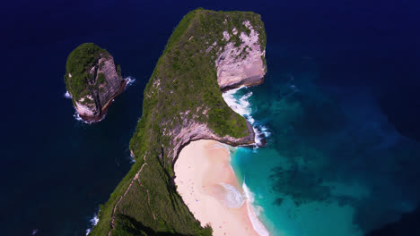 famous t-rex kelingking beach in nusa penida in dark blue sea waters