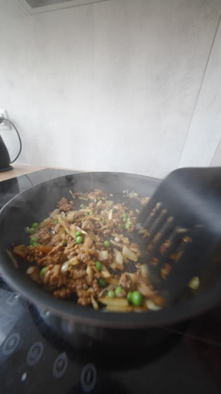 Stir-frying meat and vegetables in a pan