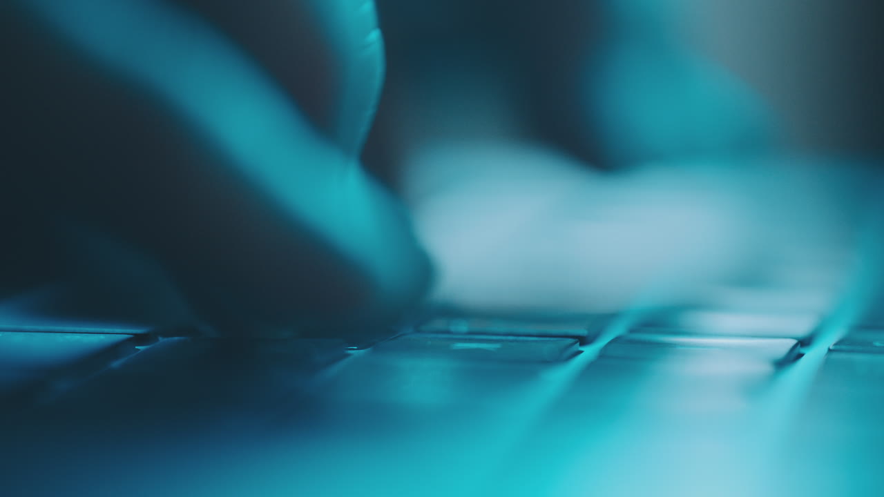Closeup of Hands Typing on a Laptop Keyboard at Night