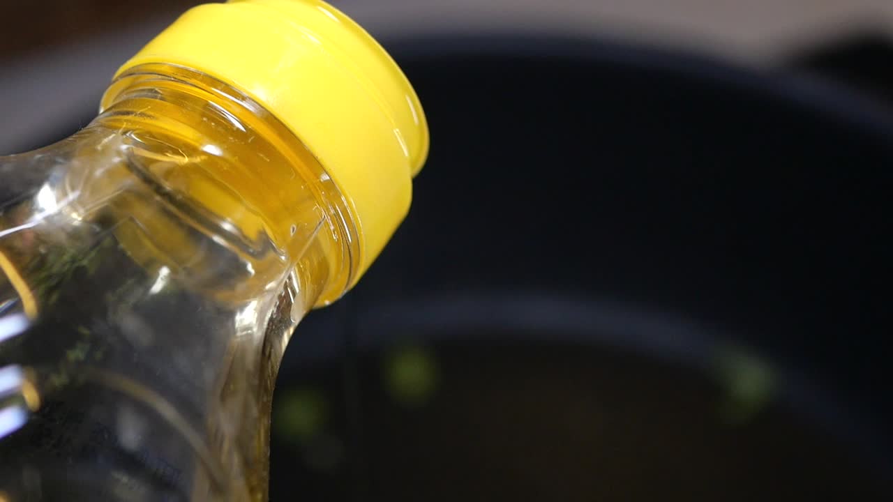 Pouring Vinegar into a Pot