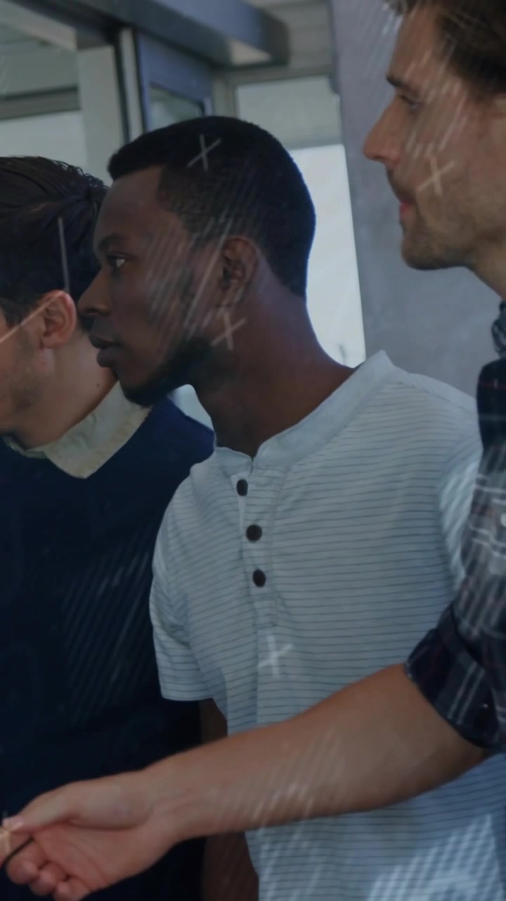 Vertical video: Right man stepping, pointing at glass wall, business team viewing diagonal overlays