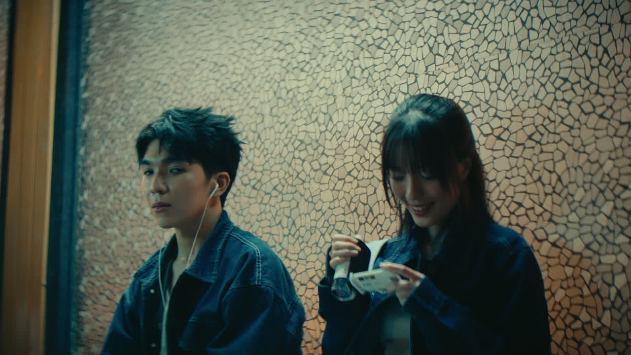 couple of young artist sitting while listening music and recording video