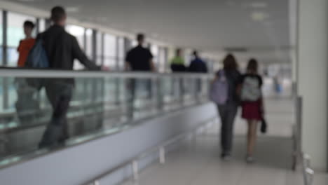 people walking through the airport passageway