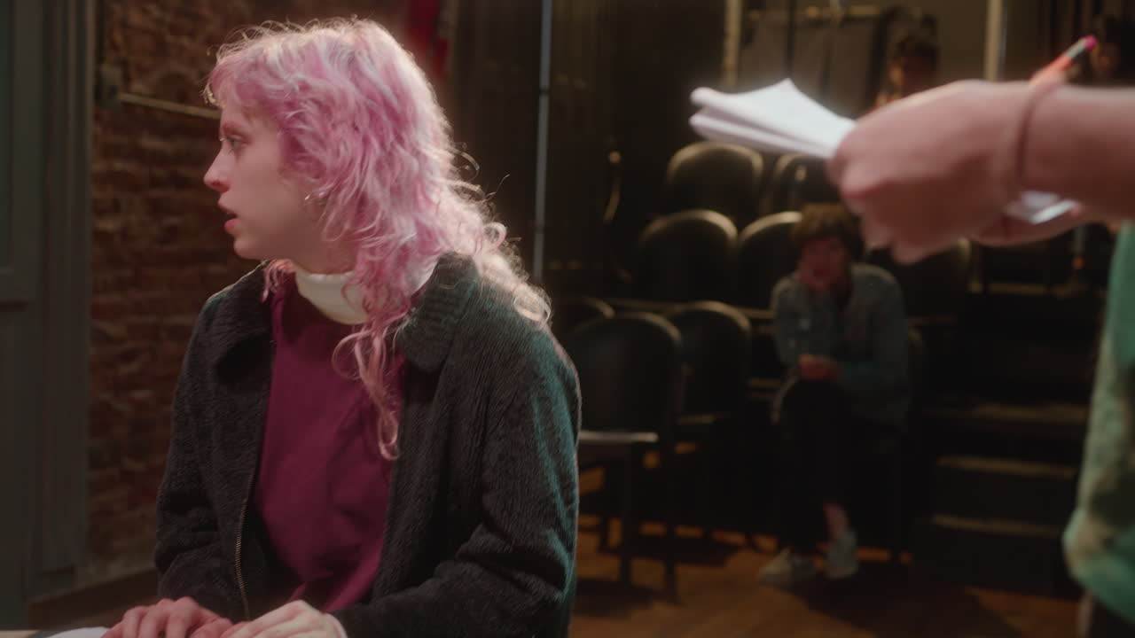 Stage Director Rehearsing Romantic Scene with Young Actors