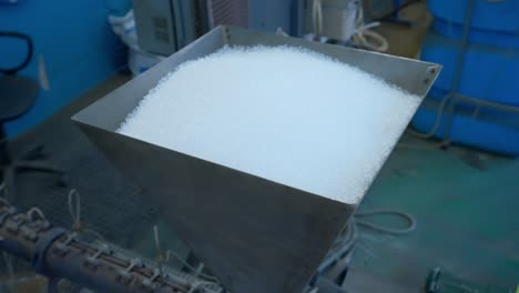 plastic pellets in a hopper at a manufacturing facility