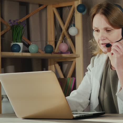 the woman communicates with customers from home by speaking into the headset 2