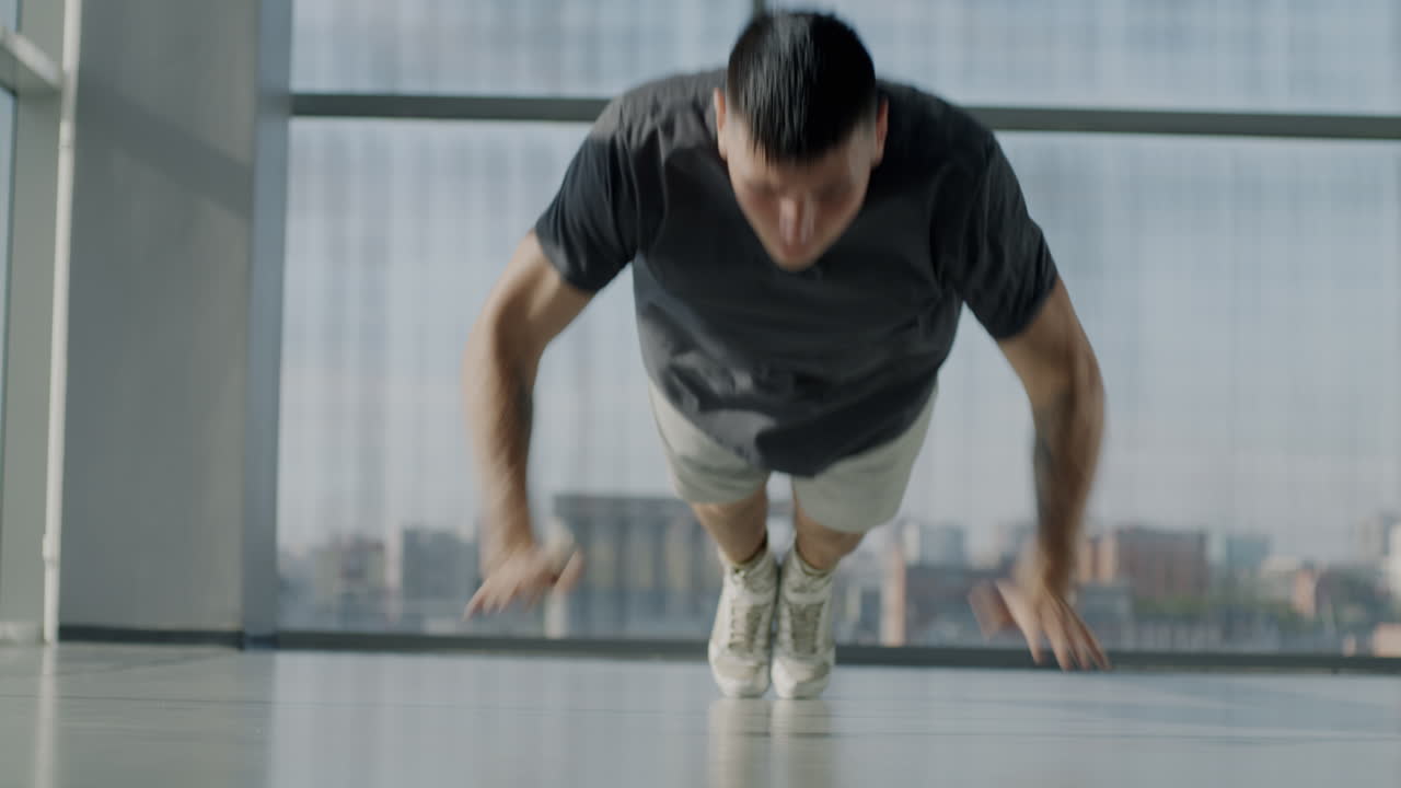 Man doing push-ups in a modern gym