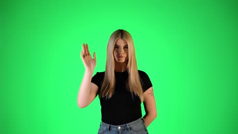 attractive blonde woman waving hand, greeting gesture, colorful studio portrait