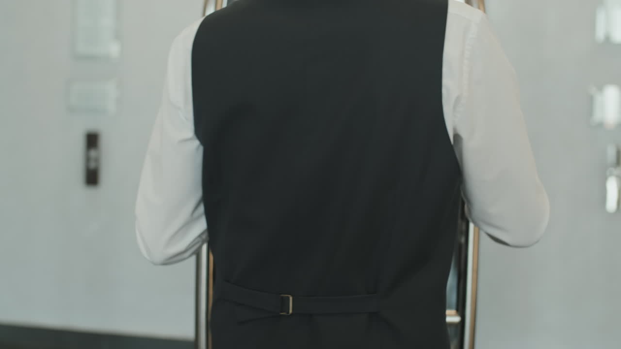 Gloved Porter Carrying Baggage Cart