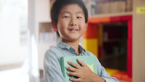 young boy with a book in a library