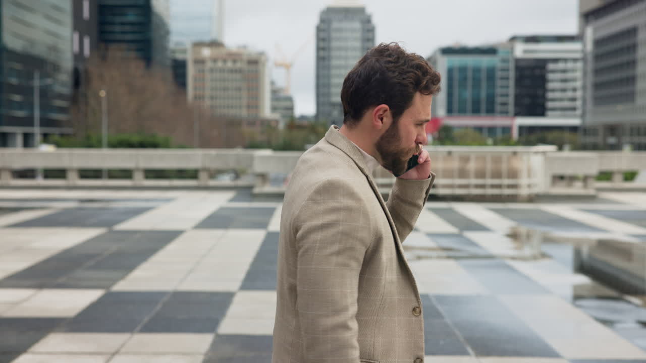 A man in a suit talking on the phone in the city