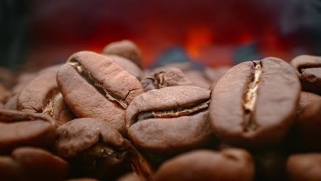 close up of seeds of coffee. fragrant coffee beans are roasted smoke comes from coffee beans.