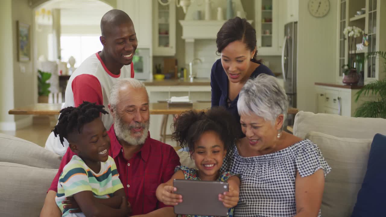 Three generation family using digital tablet at home