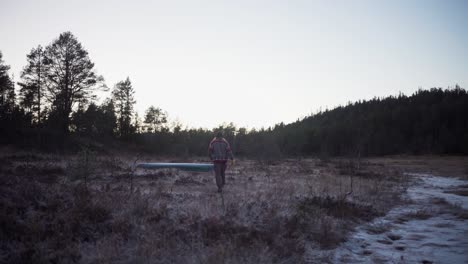 A-Man-is-Strolling-Through-the-Farm-Close-to-the-Woods---Static-Shot