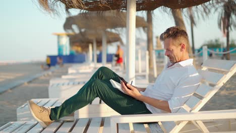 businessman surfing on smartphone on beach