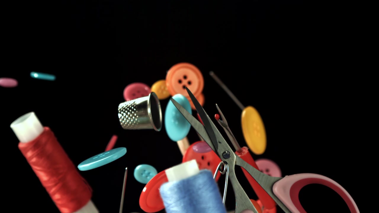 Colorful Sewing Supplies Falling and Floating in Slow Motion