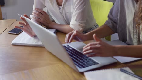 unrecognizable female students discussing new project in library, closeup