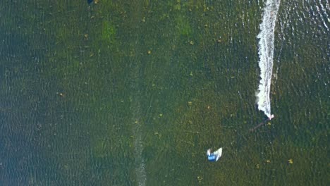 Kite-surfing-at-shallow-sea-water,-Punta-Trettu,-San-Giovanni-Suergiu,-Sardinia,-Italy