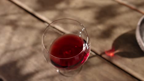 hand swirling red wine in a glass