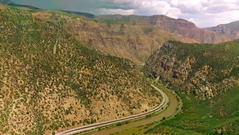 excellent panorama of beautiful mountains in colorado, usa. highways and narrow river twirling between the mountains. view from above.