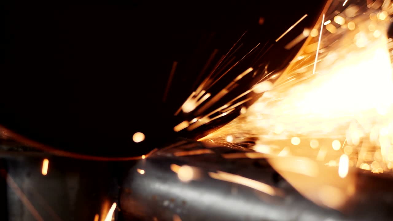 cutting pipe with saw at bright sparks shower in workshop
