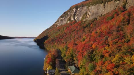 Beautiful-aerial-drone-footage-of-the-fall-leaves-on-and-around-Mount-Hor,-Mount-Pisgah,-and-Lake-Willoughby-during-peak-autumn-foliage-at-Willoughby-State-forest-in-Westmore,-Vermont