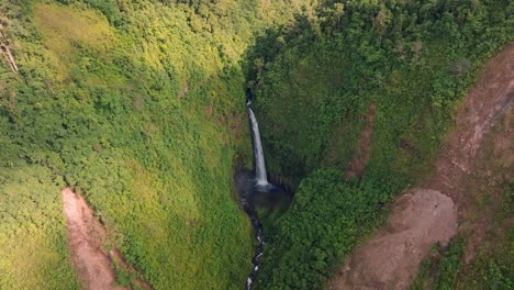 a stunning aerial view captures the beautiful catarata san fernando waterfall cascading into a vibrant, untouched green valley in costa rica