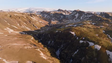 sunrise panorama aerial view mountain peaks in iceland, brown landscape