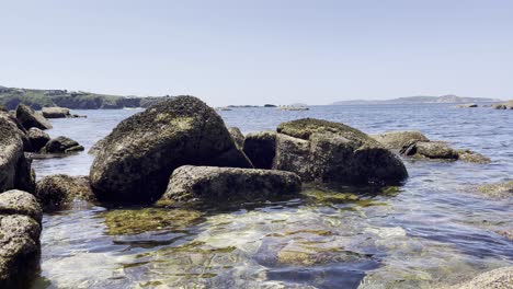 Static-Footage-of-Rocks-in-Shore-with-Clear-Water-in-Sanxenxo-Spain