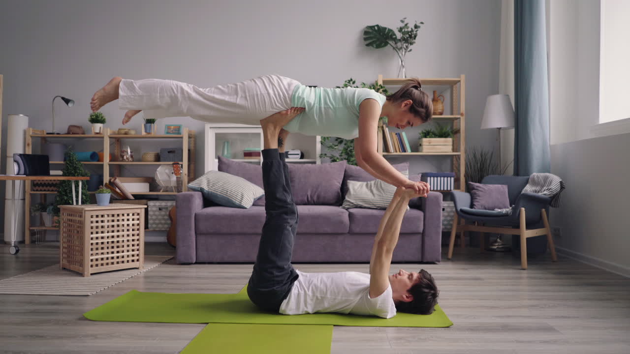 Couple Practicing Acro Yoga at Home