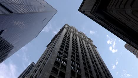 rotating low angle perspective looking up at skyscrapers in the city on a clear sunny day