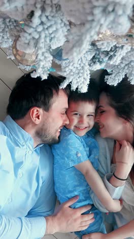 family portrait underneath christmas tree