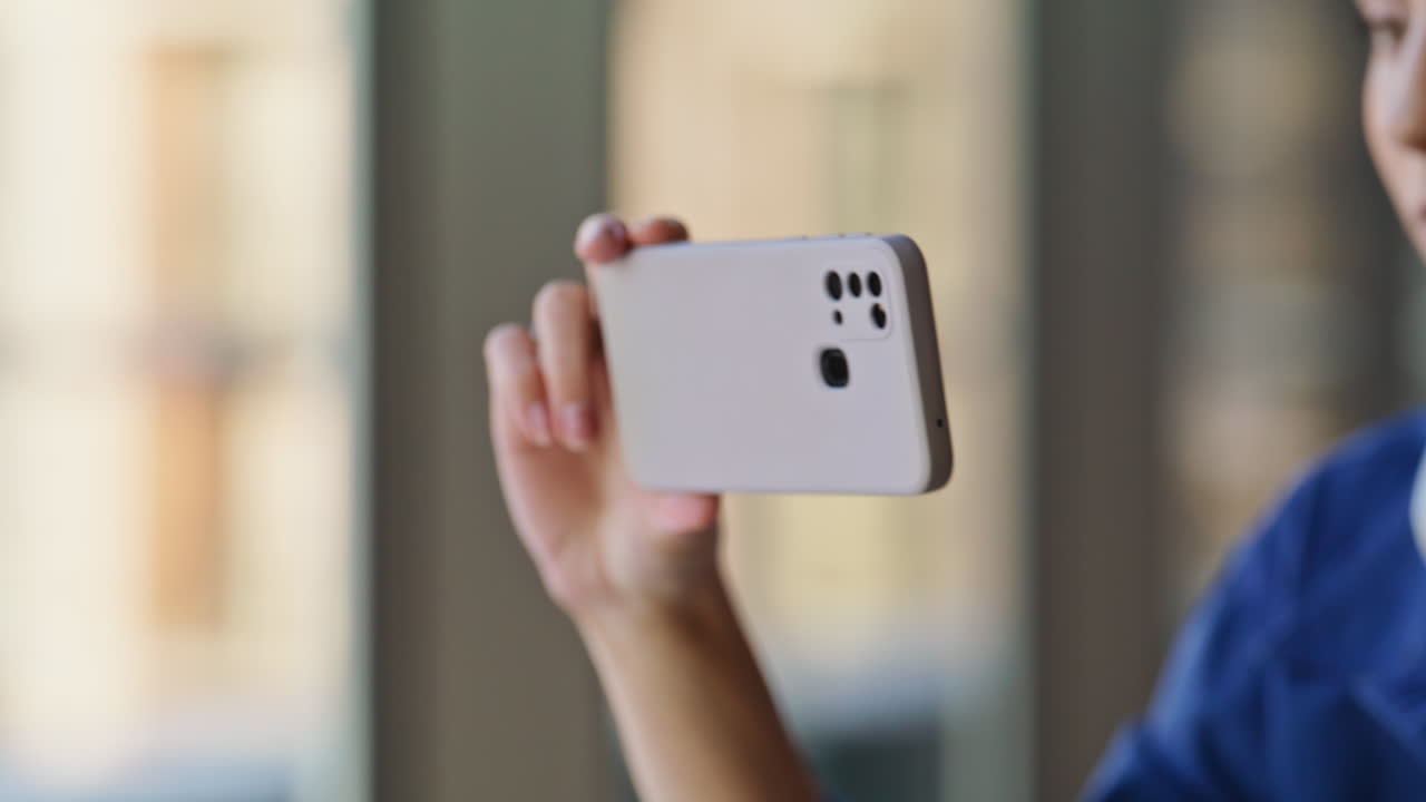 Closeup woman looking mobile phone in modern coworking office. Focused student