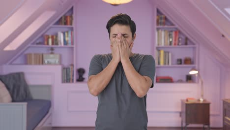 tired and lazy indian man yawning
