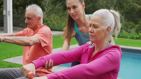 senior couple exercising in a garden